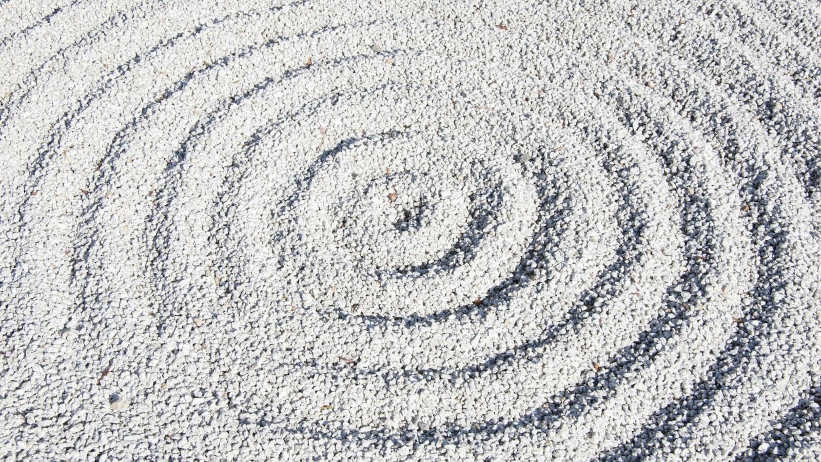 A raked gravel and stone Japanese zen garden