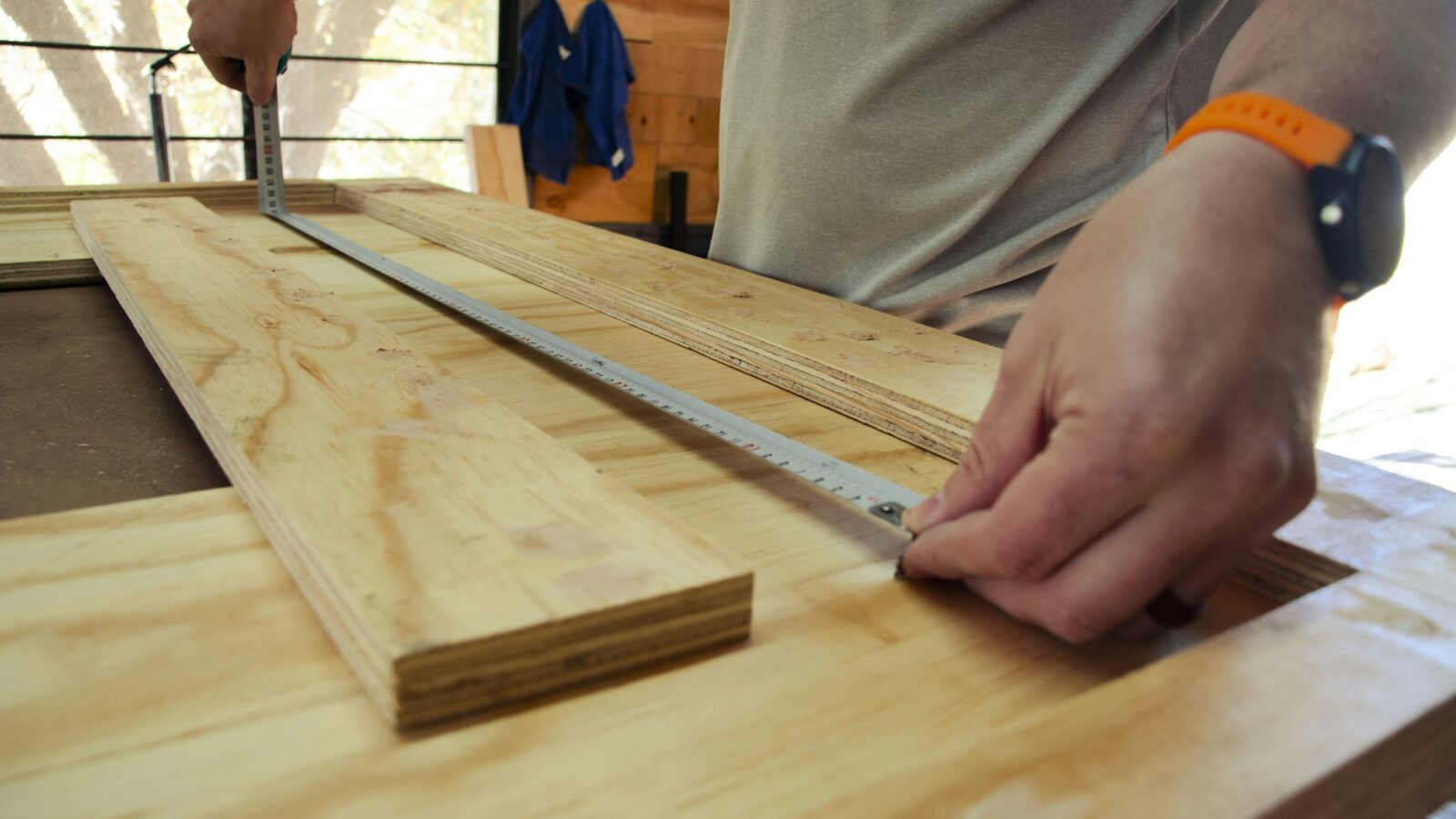 A craftsperson holding a piece of worked timber